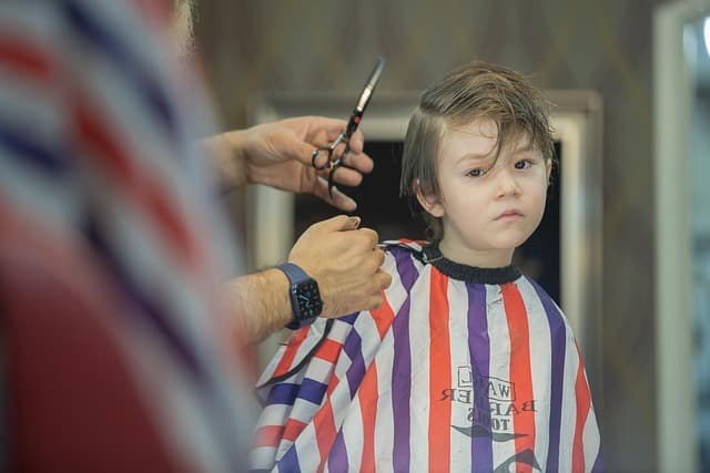 Father and son enjoying haircuts together