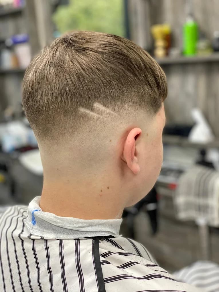 Textured crop top with a low skin fade and double-line hair design
