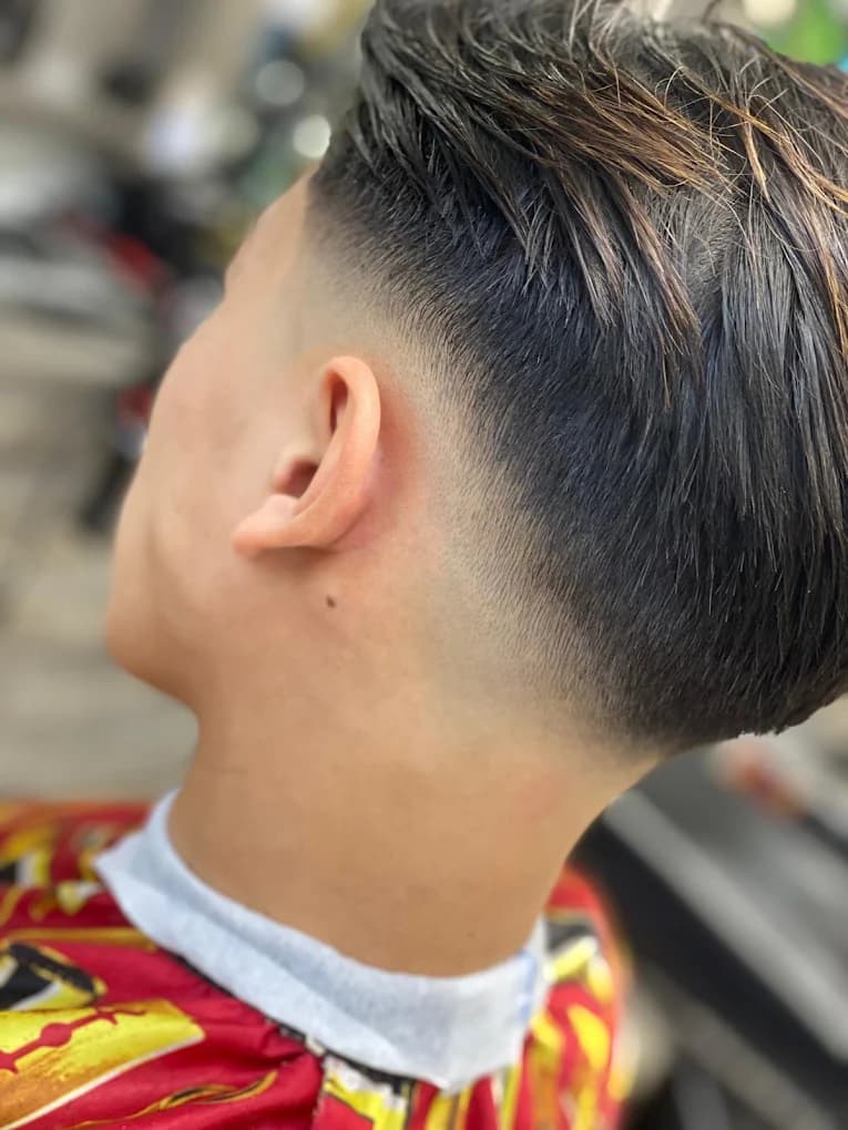 Burst fade around the ear with textured length on top and back